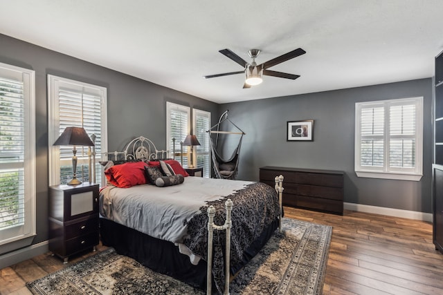 12217 Veronica Rd, Farmers Branch, TX 75234 - bedroom featuring multiple windows, hardwood / wood-style flooring, and baseboards