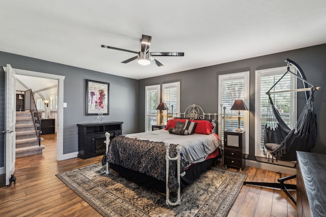 12217 Veronica Rd, Farmers Branch, TX 75234 - bedroom featuring hardwood / wood-style flooring, a ceiling fan, and baseboards