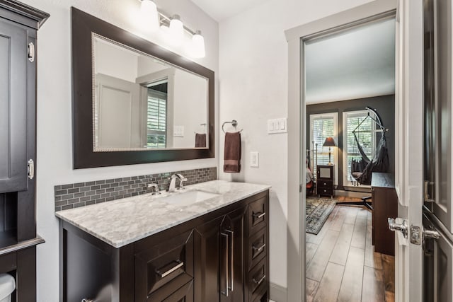 12217 Veronica Rd, Farmers Branch, TX 75234 - bathroom with vanity, backsplash, and wood finished floors