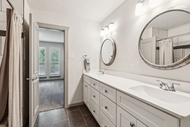 12217 Veronica Rd, Farmers Branch, TX 75234 - bathroom featuring double vanity, a shower with curtain, tile patterned floors, and baseboards