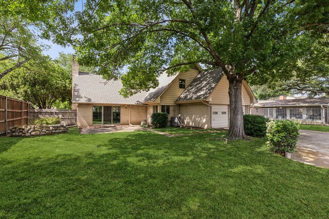 12217 Veronica Rd, Farmers Branch, TX 75234 - back of property featuring brick siding, a garage, and a chimney