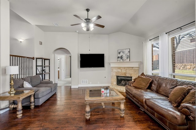 952 Tara Dr, Burleson, TX 76028 - living room featuring a ceiling fan, arched walkways, lofted ceiling, wood finished floors, and a stone fireplace