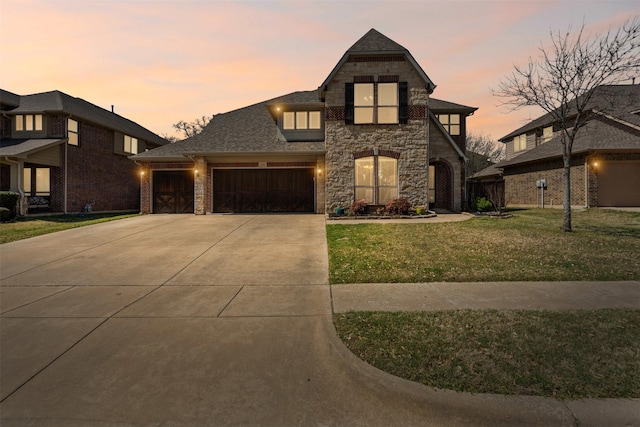 952 Tara Dr, Burleson, TX 76028 - view of front of property with stone siding, an attached garage, a lawn, driveway, and a shingled roof