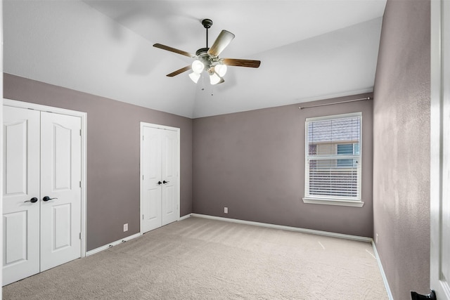 952 Tara Dr, Burleson, TX 76028 - unfurnished bedroom with two closets, carpet flooring, lofted ceiling, baseboards, and a ceiling fan