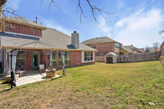 952 Tara Dr, Burleson, TX 76028 - rear view of property with a patio, brick siding, a chimney, roof with shingles, and a fire pit