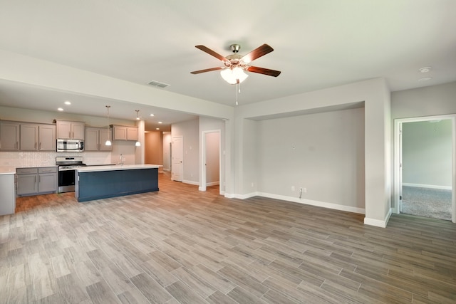 524 Big Horn Pass, Denton, TX 76210 - unfurnished living room with ceiling fan, baseboards, light wood finished floors, and recessed lighting