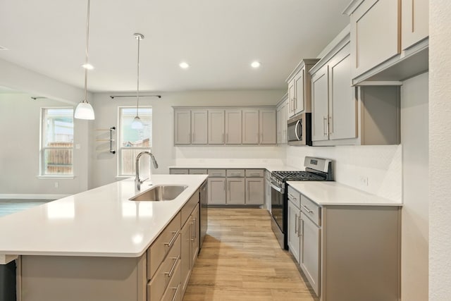 524 Big Horn Pass, Denton, TX 76210 - kitchen with appliances with stainless steel finishes, a sink, gray cabinets, light wood-style floors, and recessed lighting
