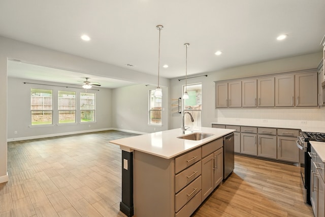 524 Big Horn Pass, Denton, TX 76210 - kitchen featuring a sink, stainless steel appliances, gray cabinets, a ceiling fan, and a center island with sink