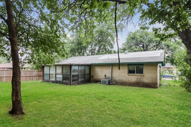 214 Independence Dr, Garland, TX 75043 - back of house featuring a sunroom, central air condition unit, and brick siding
