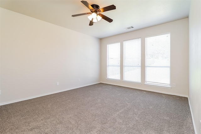 1012 Fairweather Dr, Fort Worth, TX 76120 - spare room featuring dark carpet, a ceiling fan, and baseboards