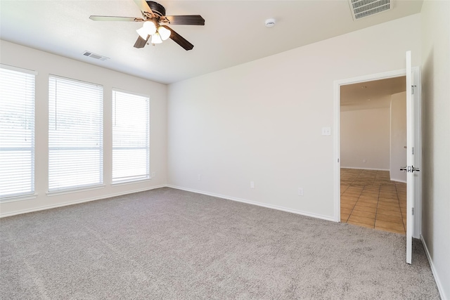 1012 Fairweather Dr, Fort Worth, TX 76120 - carpeted spare room featuring a ceiling fan, baseboards, tile patterned floors, and a smoke detector