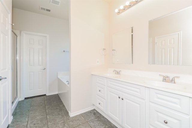 1012 Fairweather Dr, Fort Worth, TX 76120 - bathroom featuring double vanity, a garden tub, and baseboards