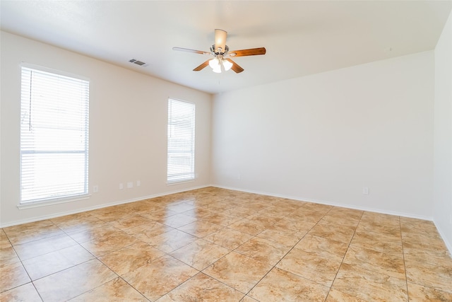 1012 Fairweather Dr, Fort Worth, TX 76120 - empty room with ceiling fan, light tile patterned floors, and baseboards