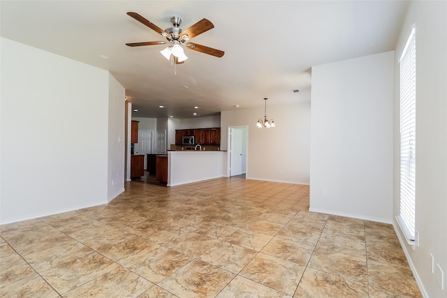 1012 Fairweather Dr, Fort Worth, TX 76120 - unfurnished living room featuring a chandelier, a ceiling fan, and baseboards