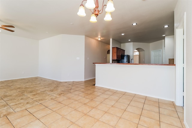 1012 Fairweather Dr, Fort Worth, TX 76120 - unfurnished living room featuring arched walkways, ceiling fan, recessed lighting, a chandelier, and light tile patterned floors
