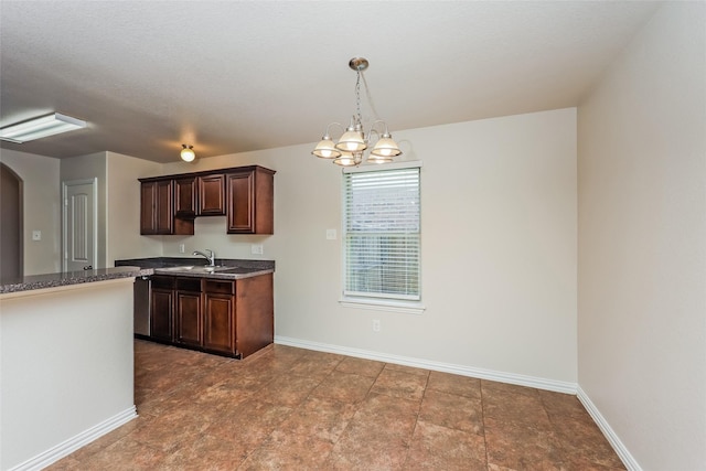 7660 Hollow Forest Dr, Fort Worth, TX 76123 - kitchen with dark brown cabinetry, pendant lighting, a chandelier, baseboards, and a sink