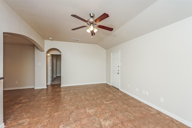 7660 Hollow Forest Dr, Fort Worth, TX 76123 - empty room with arched walkways, ceiling fan, stone finish floors, and baseboards