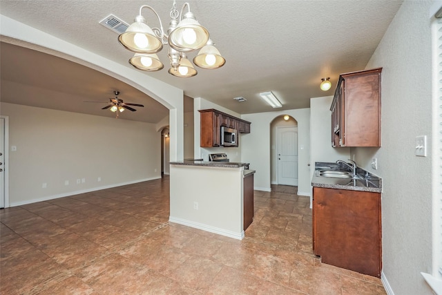 7660 Hollow Forest Dr, Fort Worth, TX 76123 - kitchen featuring arched walkways, appliances with stainless steel finishes, a sink, ceiling fan, and a chandelier
