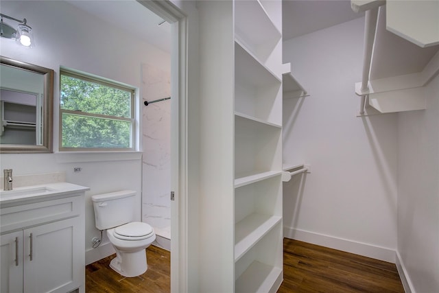312 Beckham St, Sulphur Springs, TX 75482 - full bathroom with a stall shower, toilet, vanity, and wood finished floors