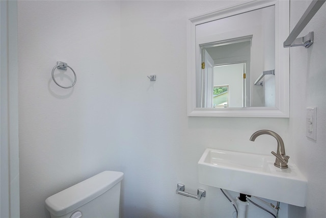 312 Beckham St, Sulphur Springs, TX 75482 - half bathroom featuring toilet and a sink