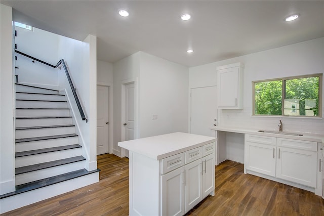 312 Beckham St, Sulphur Springs, TX 75482 - kitchen with a sink, wood finished floors, white cabinets, decorative backsplash, and recessed lighting