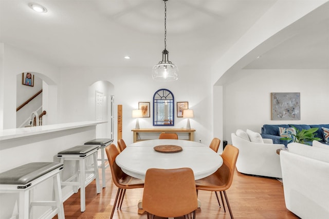 2081 Ashbourne Dr, Rockwall, TX 75087 - dining space with arched walkways, light wood finished floors, and recessed lighting