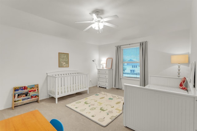 2081 Ashbourne Dr, Rockwall, TX 75087 - bedroom featuring a nursery area, carpet flooring, a ceiling fan, and baseboards