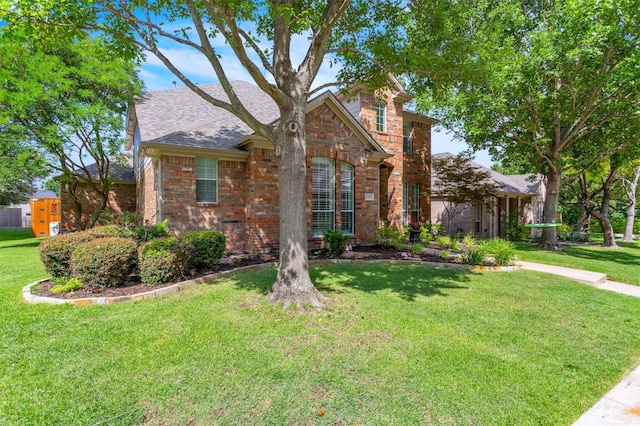 2081 Ashbourne Dr, Rockwall, TX 75087 - traditional home with brick siding, a front yard, and roof with shingles