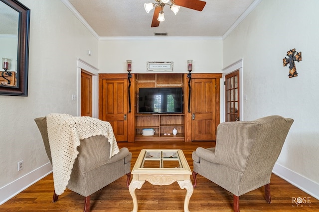 112 5th Ave, Coleman, TX 76834 - living area featuring ornamental molding, ceiling fan, baseboards, and wood finished floors