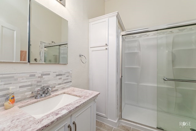 112 5th Ave, Coleman, TX 76834 - full bathroom with a shower stall, vanity, and tasteful backsplash