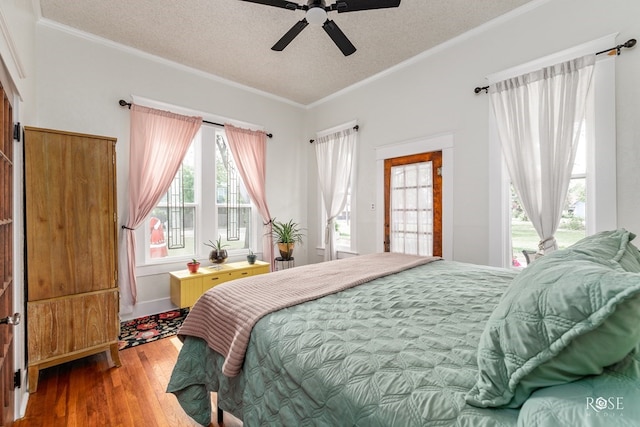 112 5th Ave, Coleman, TX 76834 - bedroom with wood finished floors, a textured ceiling, crown molding, and a ceiling fan