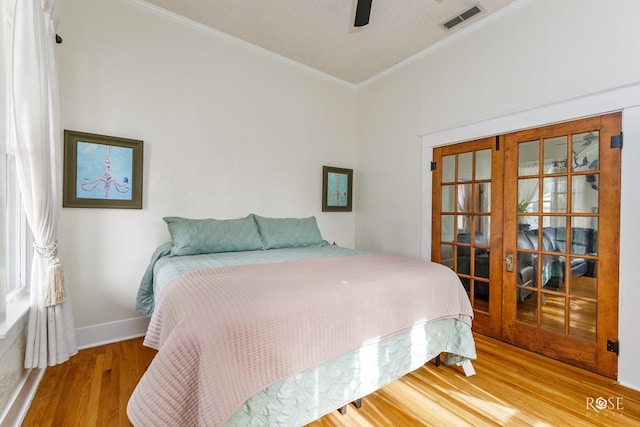 112 5th Ave, Coleman, TX 76834 - bedroom featuring crown molding, wood finished floors, french doors, baseboards, and ceiling fan