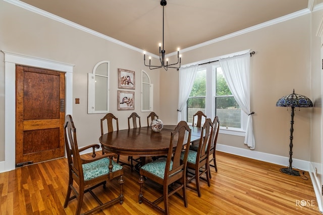112 5th Ave, Coleman, TX 76834 - dining area with ornamental molding, light wood-style flooring, baseboards, and a chandelier