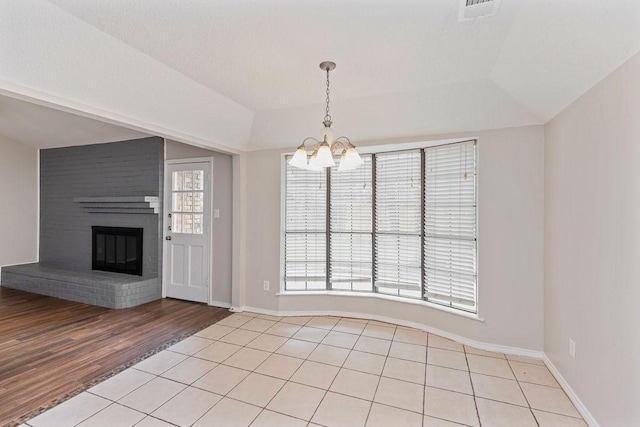 2109 Dartmouth Dr, Arlington, TX 76015 - unfurnished living room featuring a chandelier, light wood-style floors, a fireplace, and baseboards