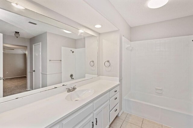 2109 Dartmouth Dr, Arlington, TX 76015 - full bath with vanity, shower / washtub combination, tile patterned floors, and a textured ceiling