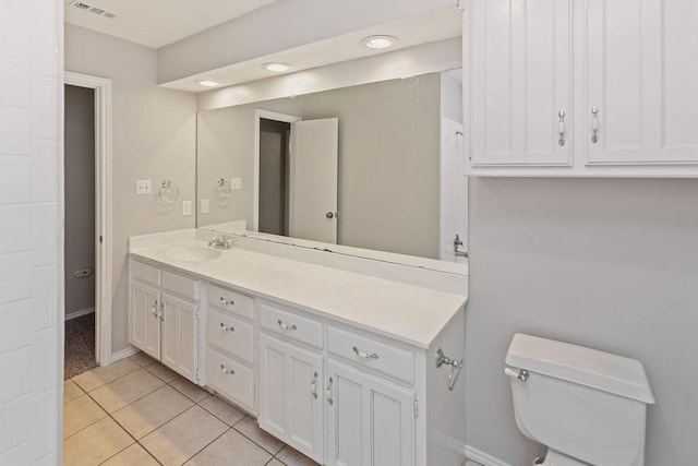 2109 Dartmouth Dr, Arlington, TX 76015 - bathroom featuring vanity, toilet, tile patterned floors, and baseboards
