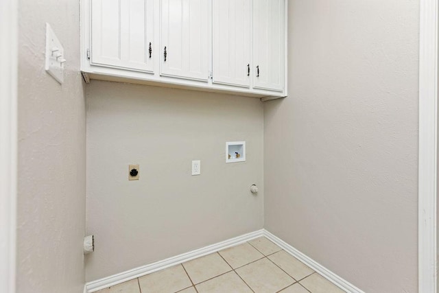 2109 Dartmouth Dr, Arlington, TX 76015 - washroom with washer hookup, baseboards, hookup for an electric dryer, cabinet space, and light tile patterned floors