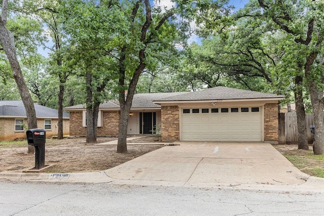 2109 Dartmouth Dr, Arlington, TX 76015 - view of front of property with a garage, concrete driveway, brick siding, and roof with shingles