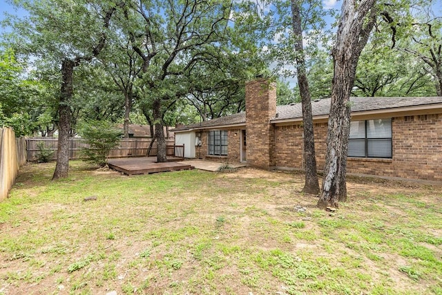 2109 Dartmouth Dr, Arlington, TX 76015 - back of property with a deck, brick siding, a chimney, and a shingled roof