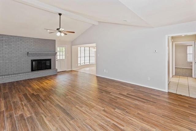 2109 Dartmouth Dr, Arlington, TX 76015 - unfurnished living room with ceiling fan, a brick fireplace, wood finished floors, and baseboards