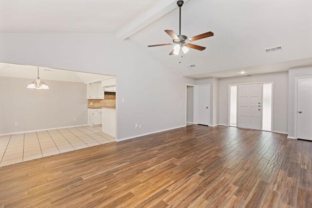2109 Dartmouth Dr, Arlington, TX 76015 - unfurnished living room with ceiling fan, a chandelier, light wood-style floors, beam ceiling, and baseboards
