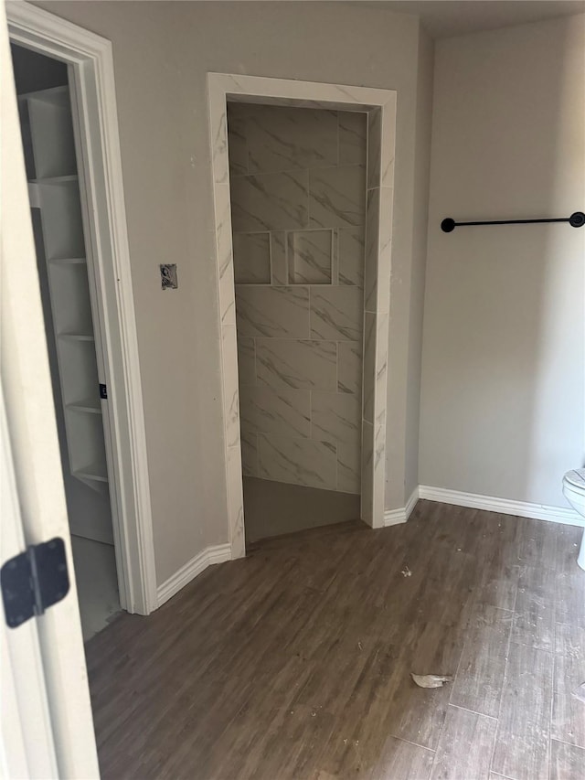 1009 Brown Ct, Poolville, TX 76487 - bathroom featuring wood finished floors, baseboards, and toilet