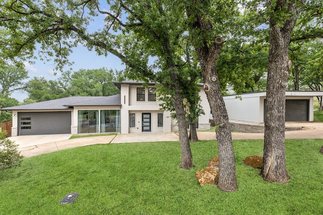 9132 Choctaw Trl, Flower Mound, TX 75022 - view of front of home featuring driveway, a front lawn, stucco siding, and a garage
