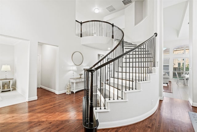 7224 Bucanero, Grand Prairie, TX 75054 - stairway with a towering ceiling, wood finished floors, and baseboards