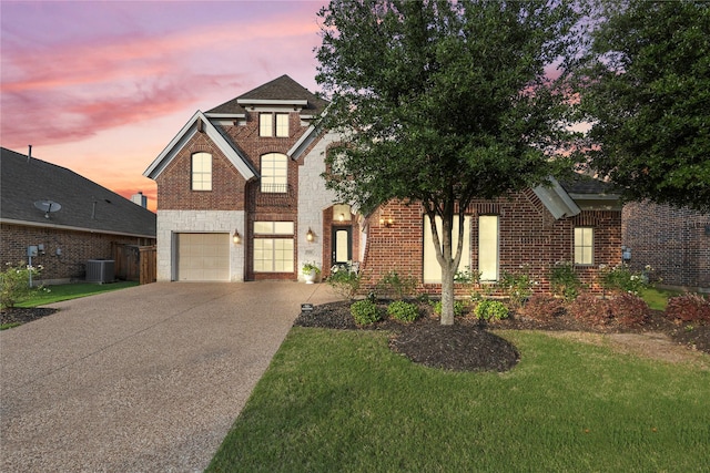 7224 Bucanero, Grand Prairie, TX 75054 - traditional-style house with cooling unit, an attached garage, driveway, brick siding, and a yard