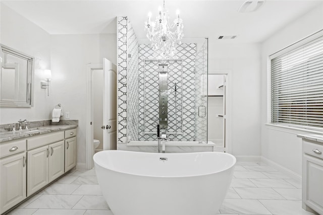 7224 Bucanero, Grand Prairie, TX 75054 - bathroom with marble look tile flooring, a freestanding tub, vanity, and a chandelier