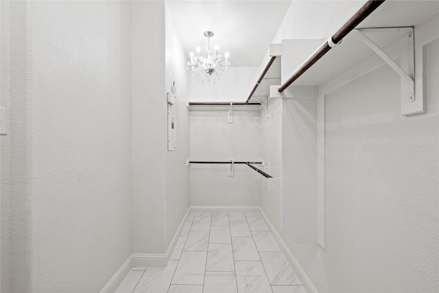 7224 Bucanero, Grand Prairie, TX 75054 - walk in closet with light marble finish floors and a chandelier
