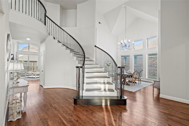 7224 Bucanero, Grand Prairie, TX 75054 - entryway with high vaulted ceiling, stairway, baseboards, a chandelier, and wood finished floors