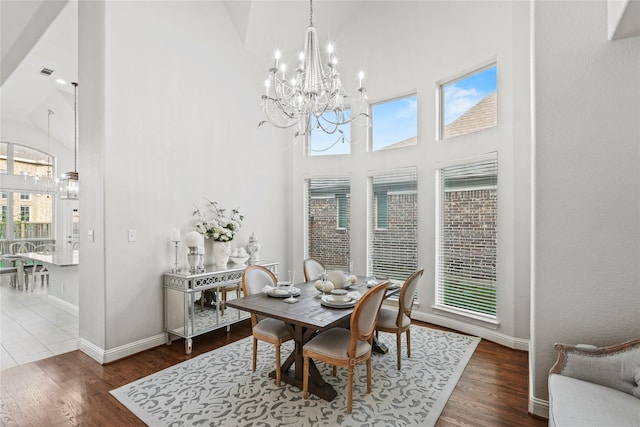 7224 Bucanero, Grand Prairie, TX 75054 - dining area featuring high vaulted ceiling, a chandelier, baseboards, and wood finished floors