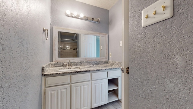 928 Thistle Ridge Ln, Arlington, TX 76017 - bathroom featuring vanity and a textured wall